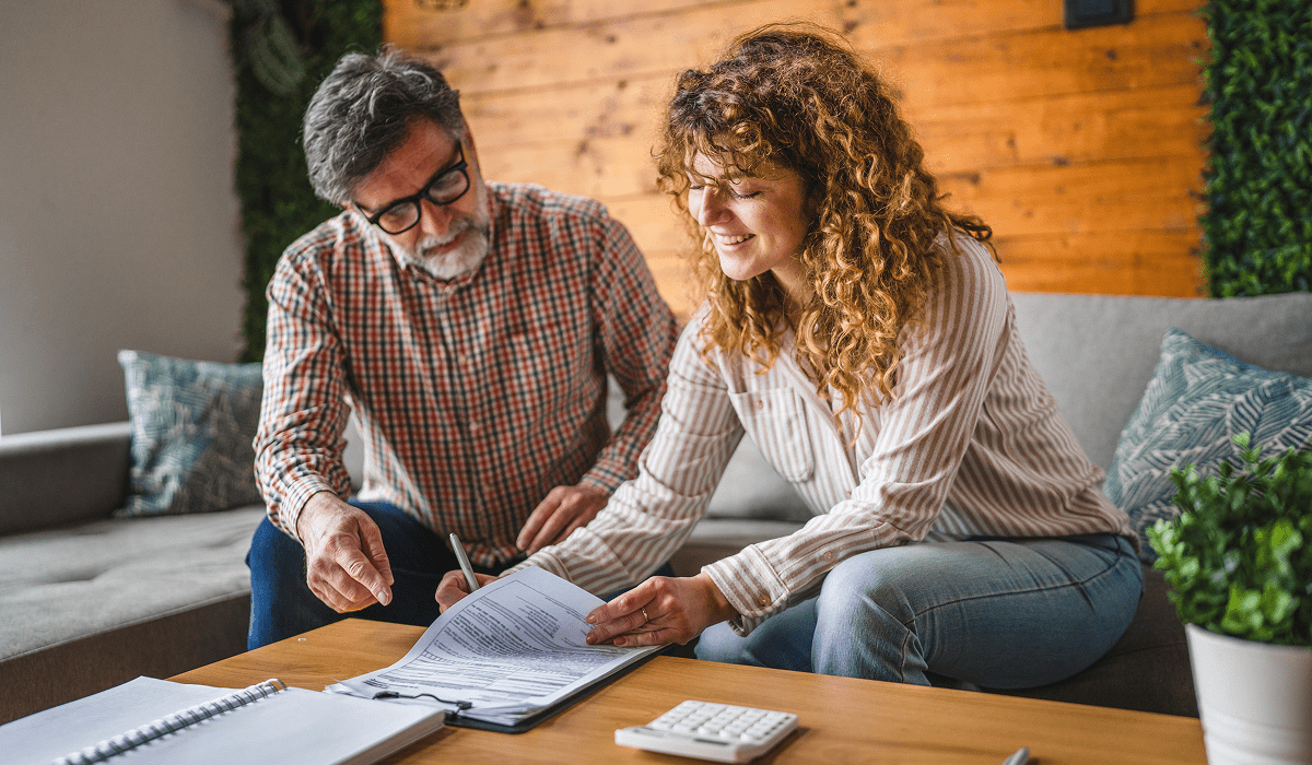 Man and woman discussing paperwork
